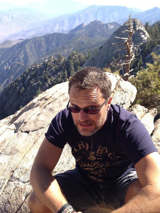 Steve Blum on a hike with mountain view background