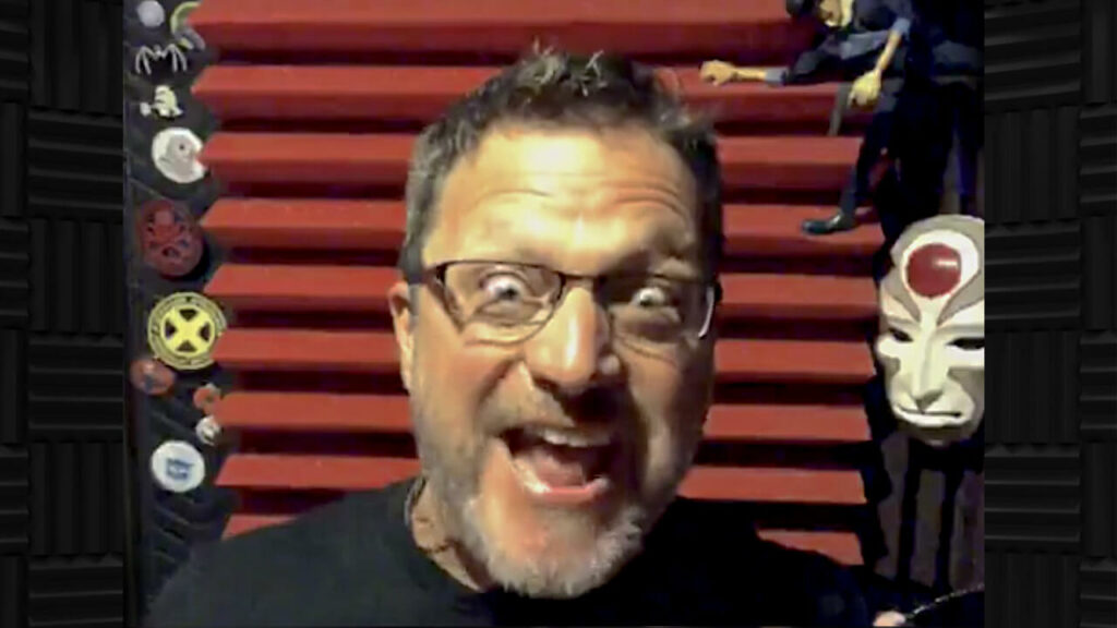 Steve Blum at the microphone making a silly face with red foam behind
