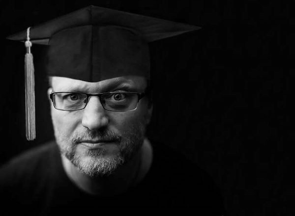 Black and White picture of Steve Blum with a graduation cap on