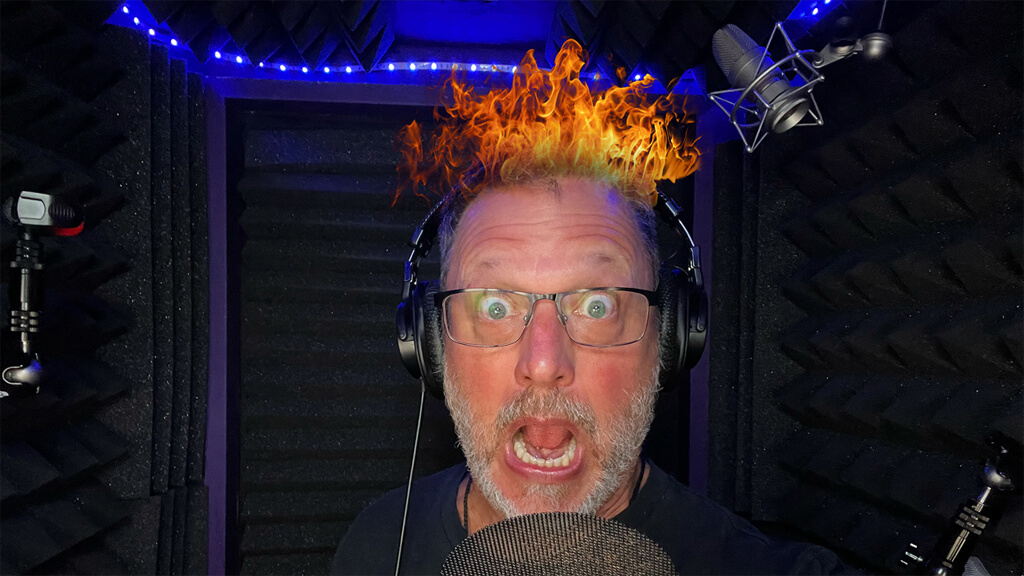 Photo of Steve in his recording booth making a silly yelling face with his hair on fire