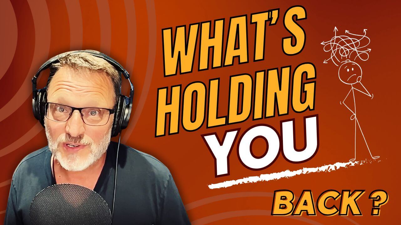 Steve Blum with headphones on and black shirt at the microphone- red background and yellow letters saying "What's Holding You Back?", as well as a pondering stick figure next to the words.